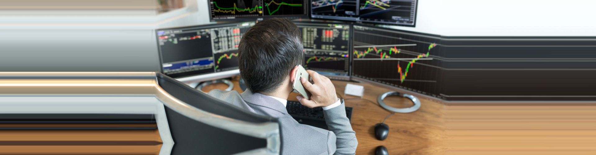 businessman having a phone call while looking the trading statistic